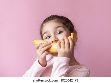 Little Girl With Yellow Banana Like Smile