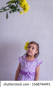 Little Girl With Yellow Flowers In Her Hair, Looks Very Tall Flower Bouquet