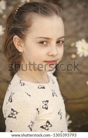 Little girl with young skin on spring or summer day. Child with cute face outdoor. Beauty kid with fresh look and long blond hair. Beauty look and skincare. Childhood and freshness.