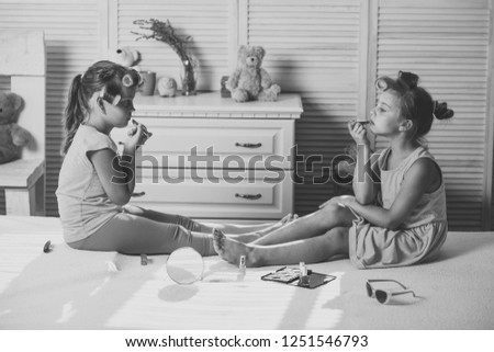 Similar – child girl playing checkers with her dad at home