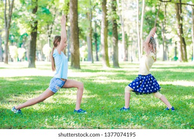 Little Girls Excersise Together In Sunshine Park