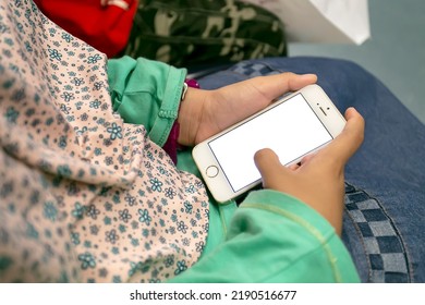 Little Girl's Hand Holding A Mobile Phone On An Electric Train In Singapore