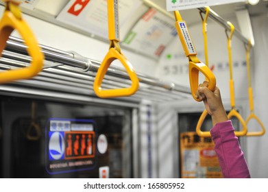 Little Girl's Hand Holding Subway Strap During Transportation