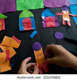 Little Girl's Hand Making A Toy Out Of Origami Paper