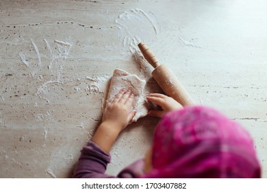 Little Girl's Hands Kneading Dough On The Table, Overhead Shot, Home Cooking Concept