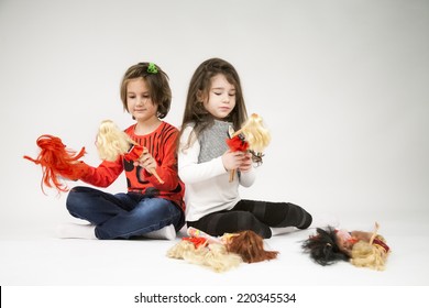 Little Girls Playing With Dolls With Light Grey Background