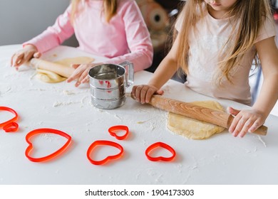 Little Girls, Sisters Cooking Homemade Heart Shaped Cookies For Valentine's Day. Holiday For All Lovers. Gift, Surprize For Mom. Red Molds, Rolling Pin, Flour, Dough.Handmade Family, Bakery With Kids.