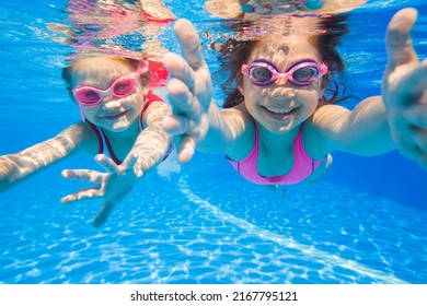 little girls swimming  in pool  underwater. - Powered by Shutterstock