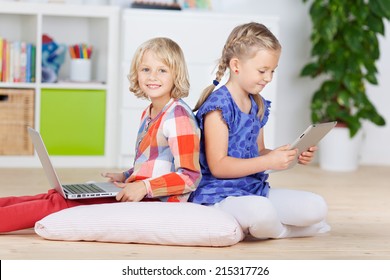 Little girls using laptop and Tablet-PC at home - Powered by Shutterstock