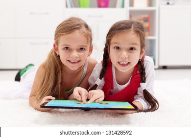 Little Girls Using Tablet Computer As Art Board - Painting Together