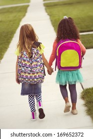 Little girls walking to school together, vintage tone
