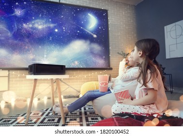 Little girls watching movie at home