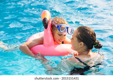 Little Girm With Mom Relaxing In A Swiming Pool At Sunny Day.