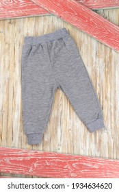 Little Gray Sports Kids Pants On Wooden Background