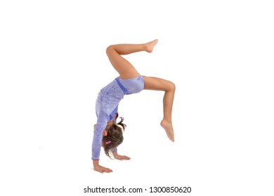 Little gymnast on a white background. Sporting exercise, stretch - Shutterstock ID 1300850620
