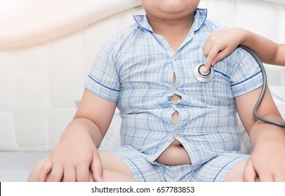 Little Hand Doctor Check Heart By Stethoscope To Obese Asian Boy, Healthcare Concept