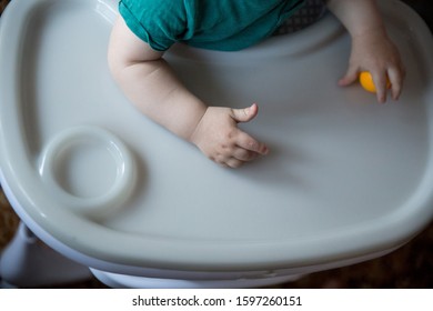 little hand of the kid who is sitting at the table