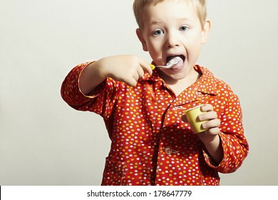 Little Handsome Boy with Yogurt. Hungry Child with Spoon. Open mouth. Enjoy Meal