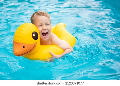 Little Happy Boy Child Swims In The Pool On A Rubber Inflatable Circle In Summer, Summer Children's Weekend, Children's Vacation, Kid In The Water Park