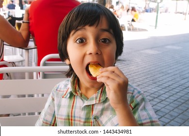 Little Happy Boy Eating Chips