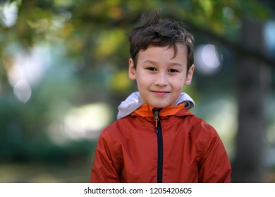 little happy boy outdoors in autumn