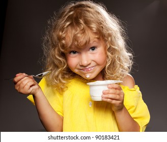 Little Happy Child Eating Yogurt