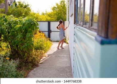 Little Happy Girl Running Around The Corner Of A House In A Summer Village