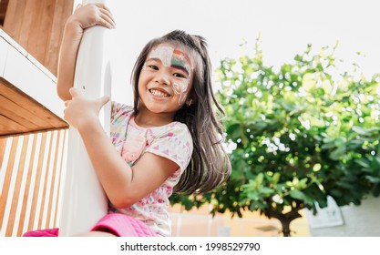 little healthy girl hanging on a bar in the playground - Powered by Shutterstock