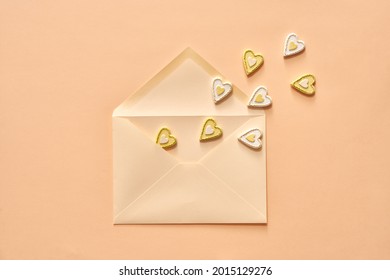 Little hearts flying out of an envelope - love or St. Valentine's concept on pastel background