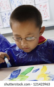 Little Hispanic Boy Painting With Friend In Art Class