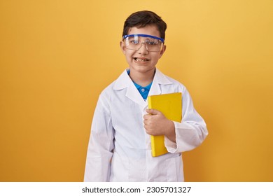 Little hispanic boy wearing scientist glasses looking positive and happy standing and smiling with a confident smile showing teeth  - Powered by Shutterstock