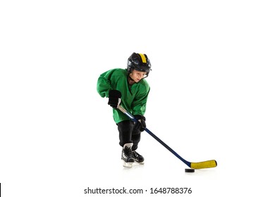 Little hockey player with the stick on ice court, white studio background. Sportsboy wearing equipment and helmet, practicing, training. Concept of sport, healthy lifestyle, motion, movement, action. - Powered by Shutterstock