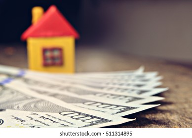 Little house and dollars background. New house concept. copy space