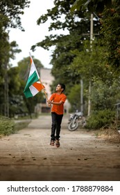 Little Indian Child Holding, Waving Or Running With Tricolour Flag