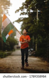 Little Indian Child Holding, Waving Or Running With Tricolour Flag