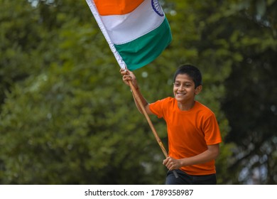 Little Indian Child Holding, Waving Or Running With Tricolour Flag