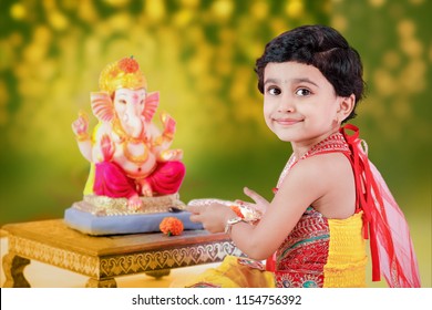 Little Indian Girl Child With Lord Ganesha And Praying , Indian Ganesh Festival