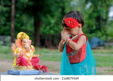 Little Indian Girl Child With Lord Ganesha And Praying , Indian Ganesh Festival