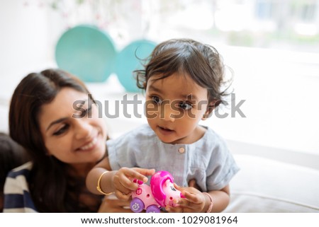 LIttle Indian girl playing with her mother