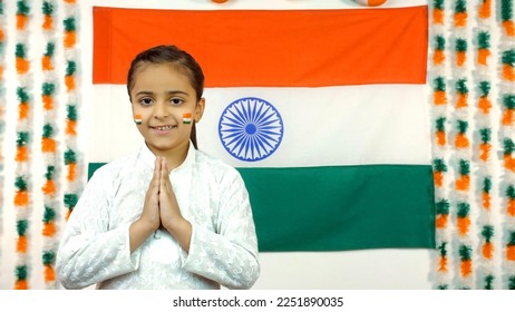 Little Indian girls celebrate the Auspicious Day - Independence Day Or Republic Day, Indian Model. Charming girl standing in a namaste position with a tricolor background, facing towards the camera... - Shutterstock ID 2251890035