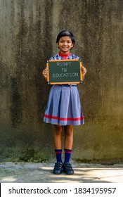 A little Indian School Girl, holding a Green Board written " Right To Education", A Concept Image. 