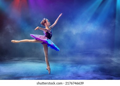 little Japanese ballerina dances on stage in a lilac tutu on pointe shoes classical ballet. - Powered by Shutterstock