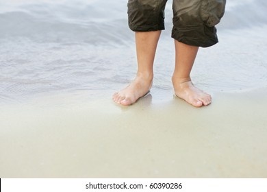 Little Kid Bare Feet In The Sea On Beach