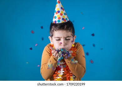 Little Kid Blowing Confetti In His Birthday