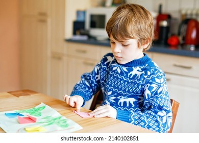 Little Kid Boy Making Paper Origami Tulip Flowers For A Postcard For Mother's Day Or Birthday. Cute Child Of Elementary Class School Doing Handicraft