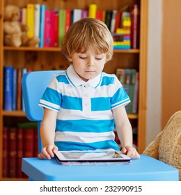 Little Kid Boy Playing With Tablet Computer In His Room At Home, Indoors. Square Format.