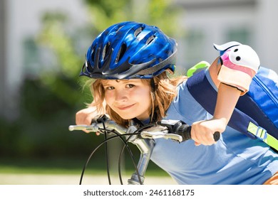 Little kid boy ride a bicycle in the park. Kid cycling on bicycle. Happy smiling child in helmet riding a bike. Boy start to ride a bicycle. Sporty kid bike riding on bikeway. Kids bicycle. - Powered by Shutterstock