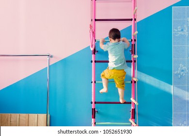 little kid climbs the stairs in the gym - Powered by Shutterstock