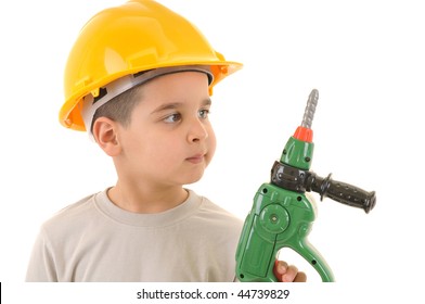 Little kid as a construction worker wearing yellow helmet holding drill like a gun.White background studio picture.