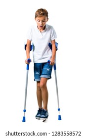 Little Kid With Crutches On Isolated White Background